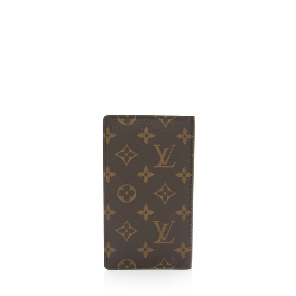 Wearing LOUIS VUITTON checkbook in monogrammed and leather coated